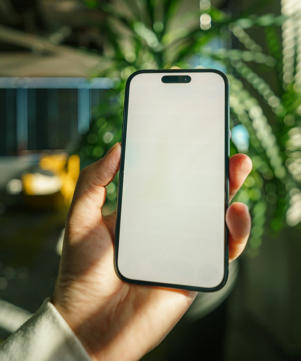 A hand holding a phone, ready for the sign-in screen