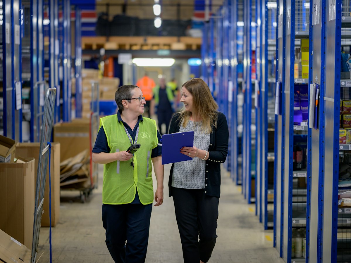 A supervisor and a warehouse worker reviewing a shortlist together